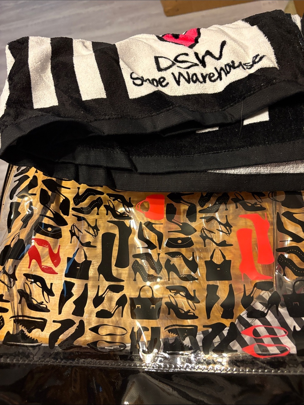 DSW Clear Pouch with Black Shoe Silhouettes and Red Accents with beach towel